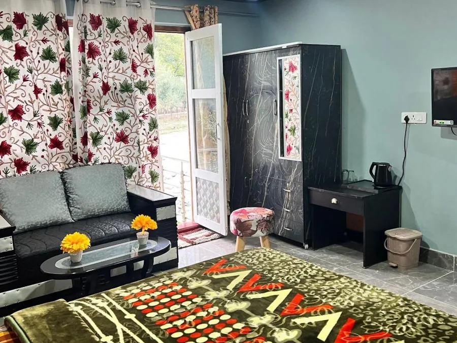 Deluxe Room at Hotel Seven Pahalgam with a sofa and window