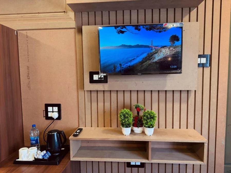 Television, kettle and shelving in the Premium Room at Hotel Seven Pahalgam